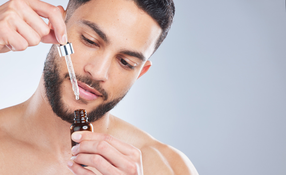 A man applying beard oil