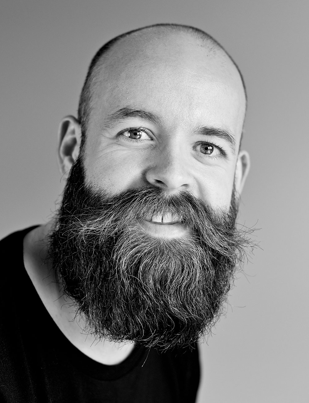 Black and white close up of a man with a full beard