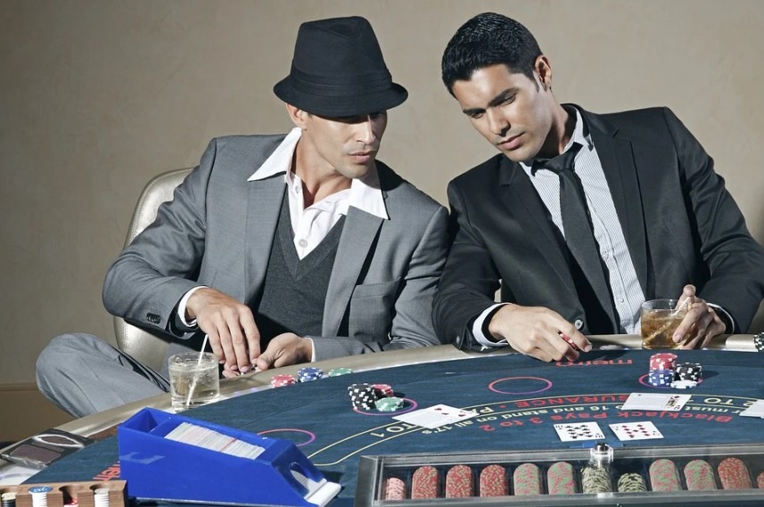 men in formal clothes playing in a casino