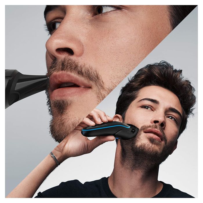 a man using a Braun trimmer on his beard and mustache