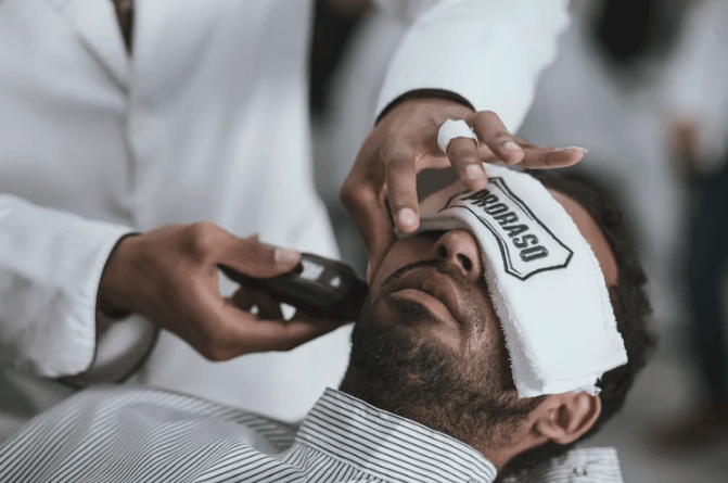 a barber using a beard trimmer