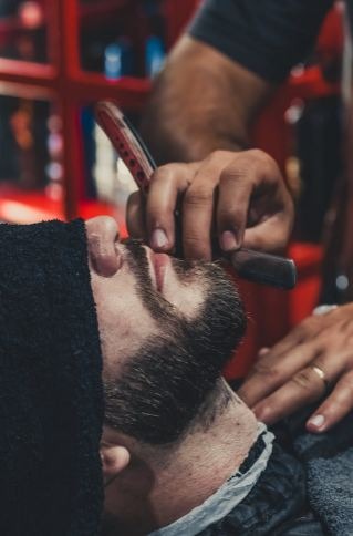 Barber Shaving A Mans Beard