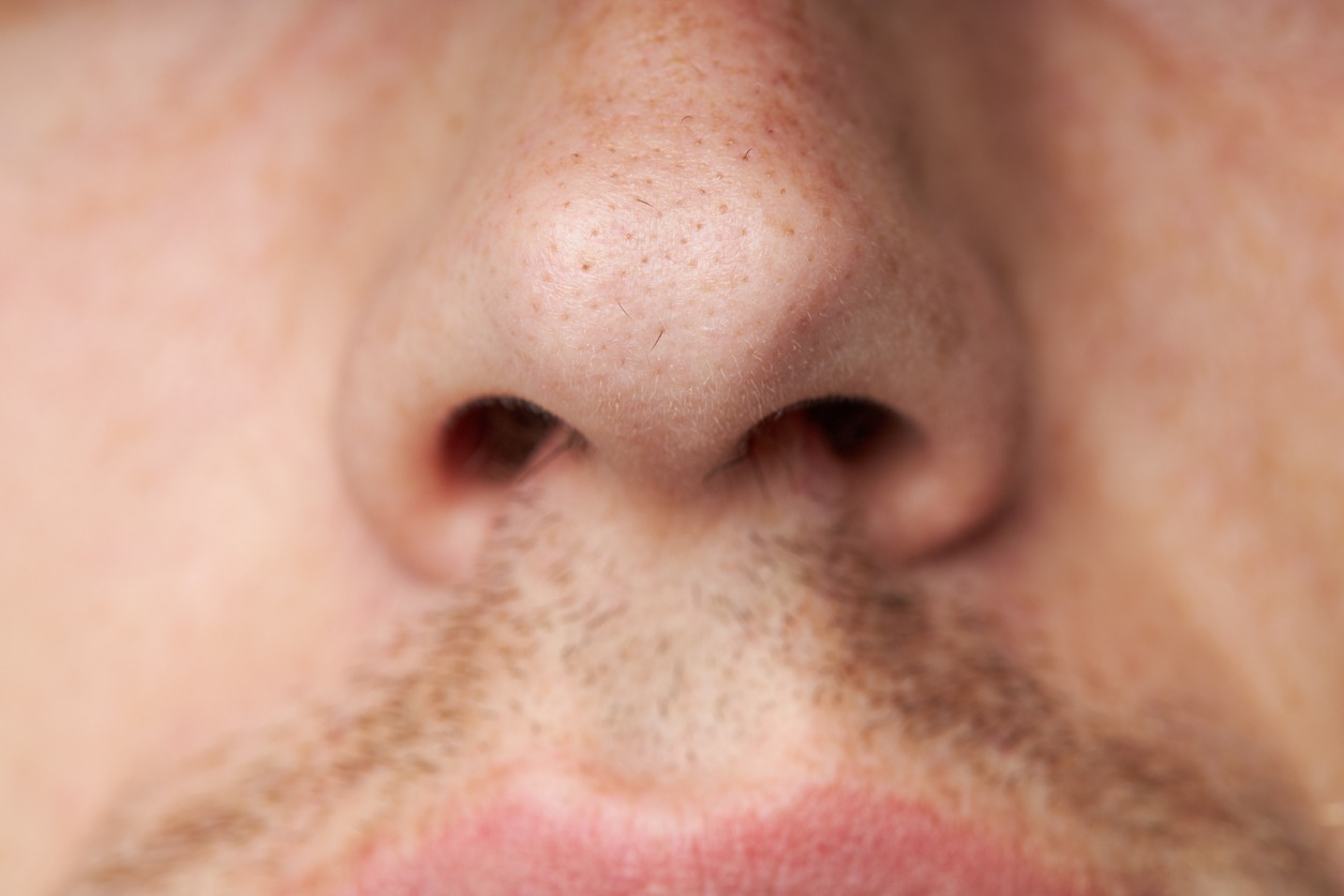 Male nose with a long hair. body care concept. macro