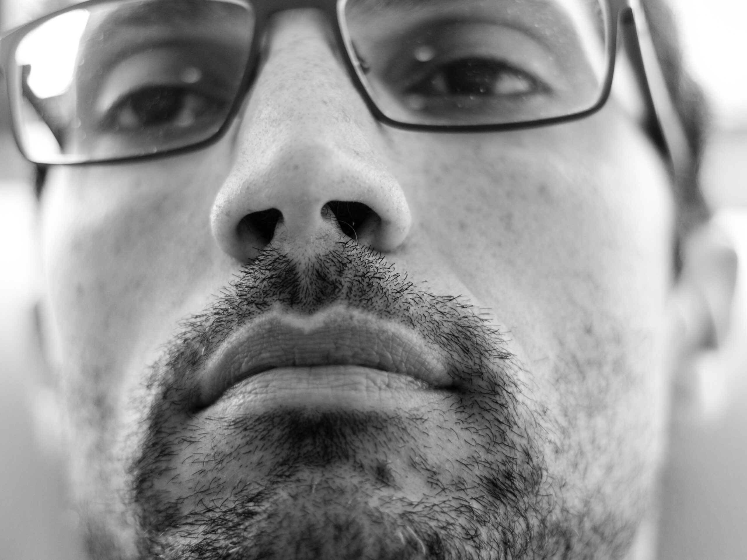 grayscale photo of man in eyeglasses